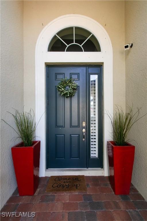 2604 Stonyhill Ct, Cape Coral, FL 33991 - entrance to property with stucco siding
