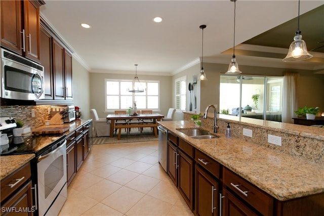 2604 Stonyhill Ct, Cape Coral, FL 33991 - kitchen featuring light tile patterned floors, ornamental molding, appliances with stainless steel finishes, a sink, and backsplash