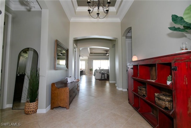 2604 Stonyhill Ct, Cape Coral, FL 33991 - hallway featuring a raised ceiling, arched walkways, light tile patterned floors, and ornamental molding
