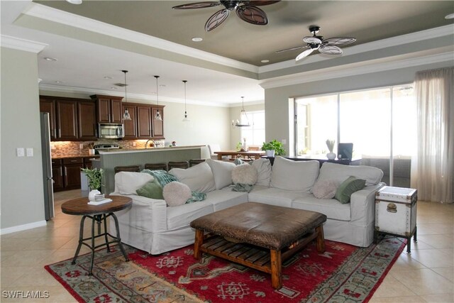 2604 Stonyhill Ct, Cape Coral, FL 33991 - living room featuring crown molding, light tile patterned floors, ceiling fan, and a raised ceiling
