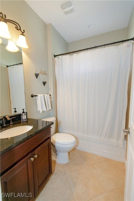 2604 Stonyhill Ct, Cape Coral, FL 33991 - full bathroom featuring vanity, tile patterned flooring, shower / bath combination with curtain, toilet, and visible vents