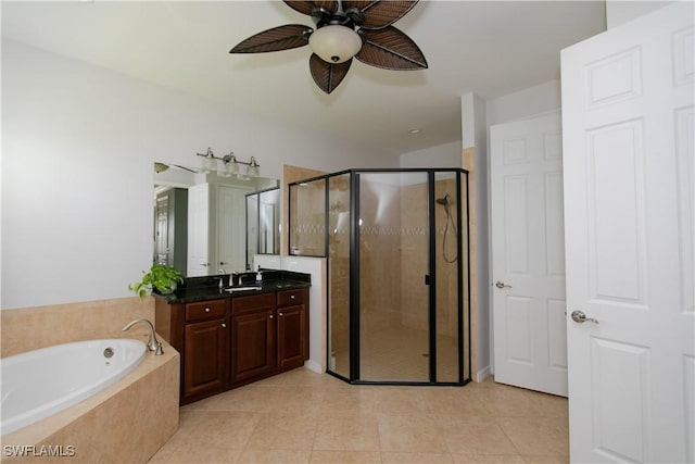 2604 Stonyhill Ct, Cape Coral, FL 33991 - full bath featuring ceiling fan, a shower stall, vanity, tile patterned flooring, and a garden tub