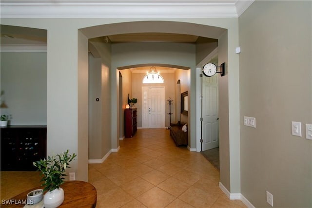 2604 Stonyhill Ct, Cape Coral, FL 33991 - hallway with ornamental molding, light tile patterned floors, baseboards, and arched walkways