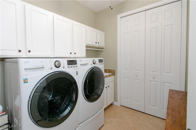 2604 Stonyhill Ct, Cape Coral, FL 33991 - laundry area featuring washing machine and clothes dryer, cabinet space, and light tile patterned floors