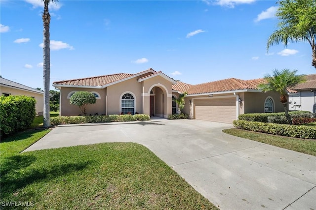 9846 Weather Stone Pl, Fort Myers, FL 33913 - mediterranean / spanish-style house with stucco siding, a tiled roof, a garage, and concrete driveway