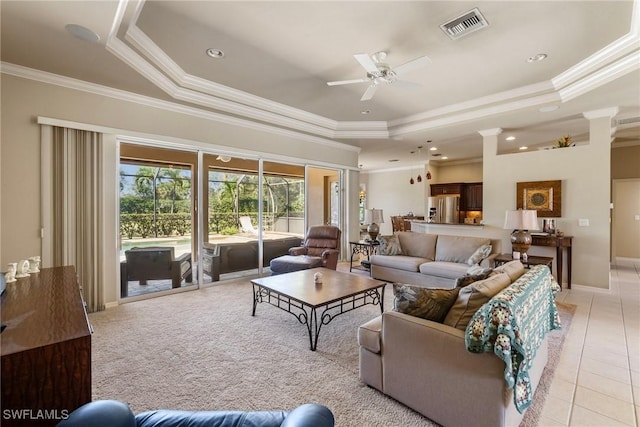 9846 Weather Stone Pl, Fort Myers, FL 33913 - living area featuring a tray ceiling, ornamental molding, a ceiling fan, light tile patterned floors, and ornate columns