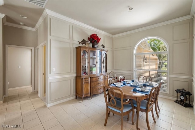 9846 Weather Stone Pl, Fort Myers, FL 33913 - dining space with a decorative wall, light tile patterned floors, and crown molding