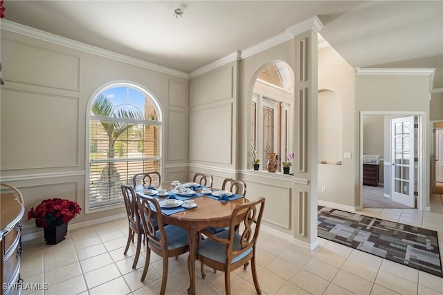 9846 Weather Stone Pl, Fort Myers, FL 33913 - dining space with a decorative wall, light tile patterned floors, plenty of natural light, ornamental molding, and arched walkways