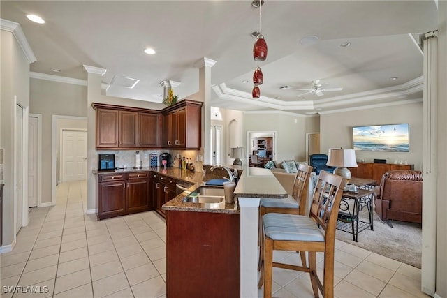 9846 Weather Stone Pl, Fort Myers, FL 33913 - kitchen with light tile patterned flooring, a peninsula, open floor plan, ornamental molding, and ceiling fan