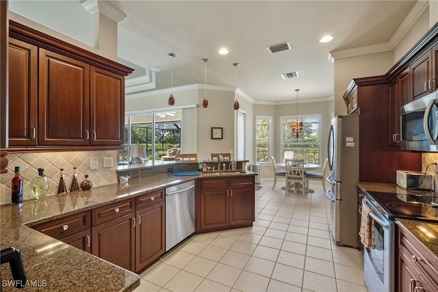 9846 Weather Stone Pl, Fort Myers, FL 33913 - kitchen featuring stainless steel appliances, light tile patterned flooring, pendant lighting, healthy amount of natural light, and recessed lighting
