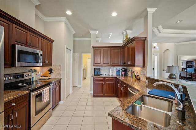 9846 Weather Stone Pl, Fort Myers, FL 33913 - kitchen featuring stainless steel appliances, light tile patterned flooring, backsplash, dark stone countertops, and crown molding