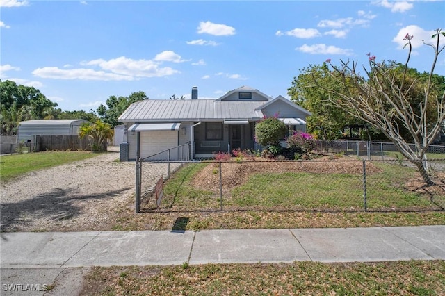 290 Granada Blvd, Fort Myers, FL 33905 - view of front of home with metal roof, fence, gravel driveway, an attached garage, and a front yard