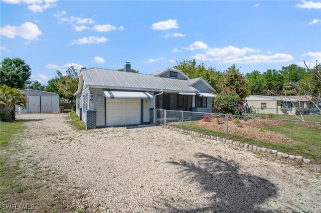 290 Granada Blvd, Fort Myers, FL 33905 - view of front facade featuring fence, metal roof, an attached garage, gravel driveway, and a chimney