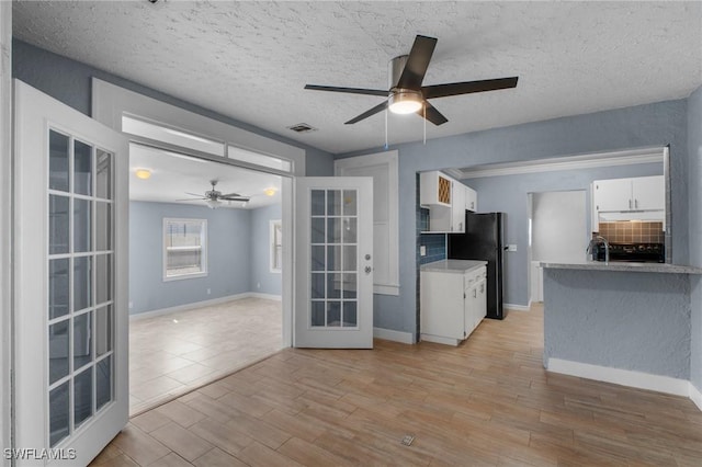 290 Granada Blvd, Fort Myers, FL 33905 - kitchen featuring french doors, white cabinetry, light wood-style flooring, visible vents, and ceiling fan