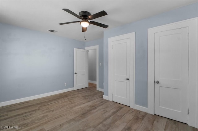 290 Granada Blvd, Fort Myers, FL 33905 - unfurnished bedroom featuring baseboards, visible vents, wood finished floors, and a ceiling fan