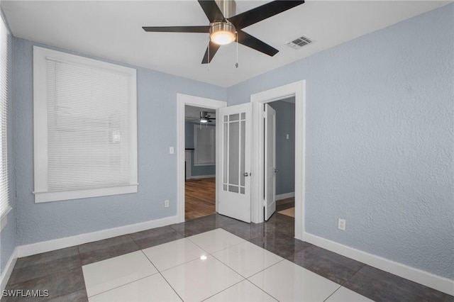 290 Granada Blvd, Fort Myers, FL 33905 - tiled spare room with visible vents, a textured wall, baseboards, and ceiling fan