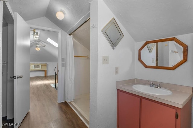 290 Granada Blvd, Fort Myers, FL 33905 - bathroom featuring vanity, vaulted ceiling, a shower with shower curtain, a textured ceiling, and wood finished floors