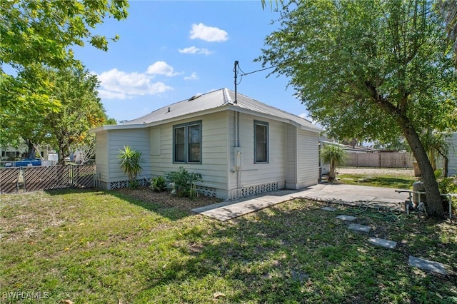 290 Granada Blvd, Fort Myers, FL 33905 - view of side of property featuring a patio area, fence, and a yard