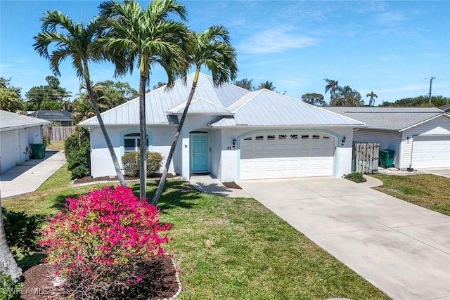 41 5th St, Bonita Springs, FL 34134 - ranch-style home with stucco siding, an attached garage, concrete driveway, and a metal roof