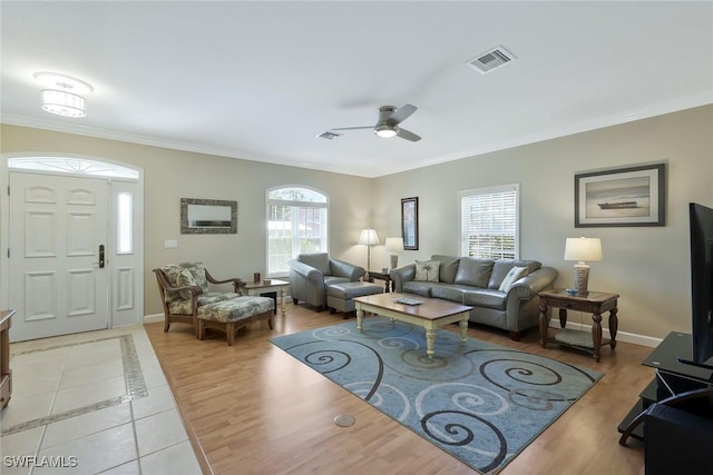 41 5th St, Bonita Springs, FL 34134 - living area with plenty of natural light, ornamental molding, ceiling fan, and light wood finished floors