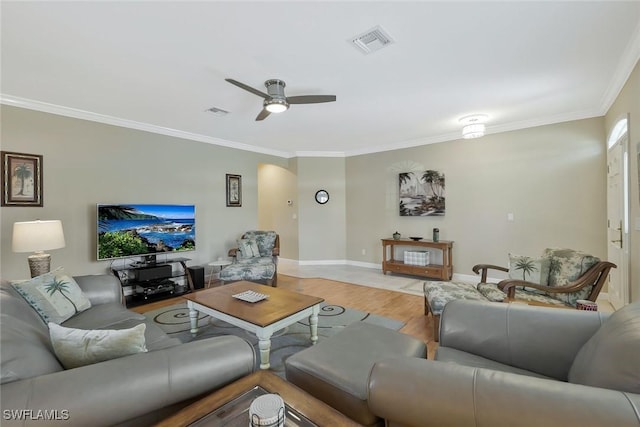 41 5th St, Bonita Springs, FL 34134 - living room with light wood-style flooring, ornamental molding, arched walkways, and ceiling fan