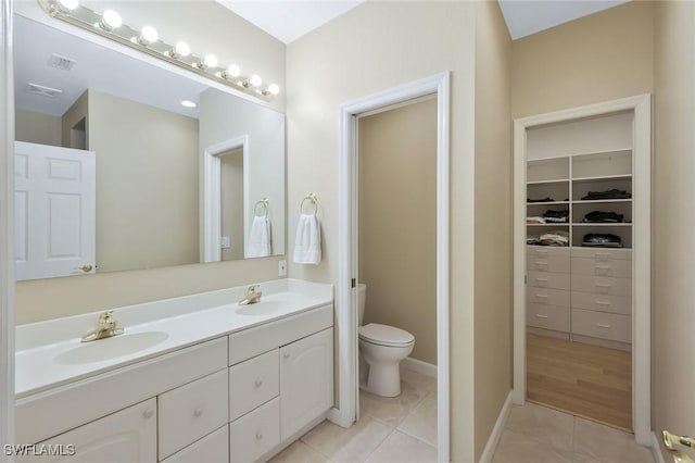 41 5th St, Bonita Springs, FL 34134 - full bathroom with double vanity, tile patterned flooring, and a spacious closet