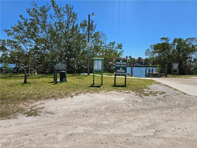 41 5th St, Bonita Springs, FL 34134 - view of property hidden behind natural elements with a front yard