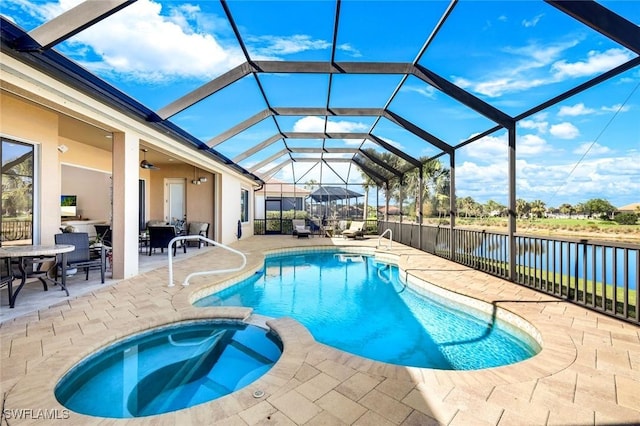 view of pool featuring a patio, fence, ceiling fan, and a pool with connected hot tub