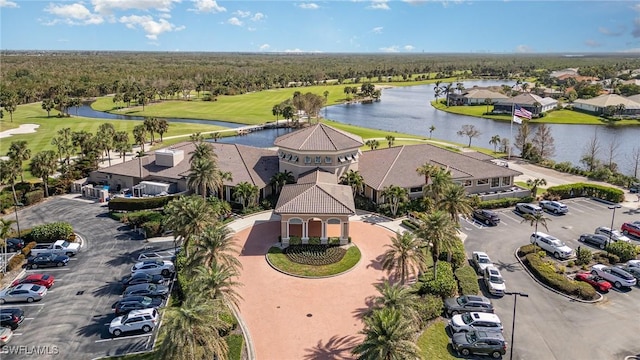 aerial view featuring golf course view, a water view, and a residential view