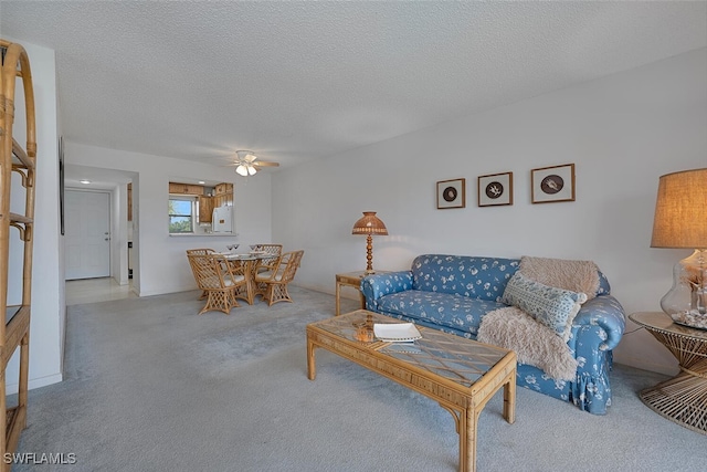 4146 27th Ct SW Unit 204, Naples, FL 34116 - living room with carpet flooring, a ceiling fan, and a textured ceiling