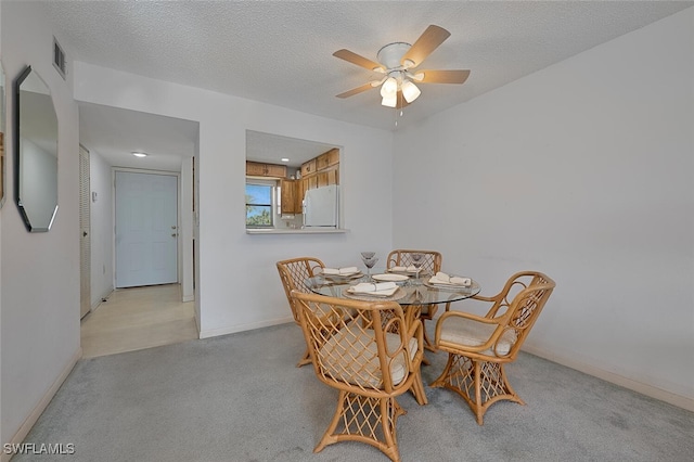 4146 27th Ct SW Unit 204, Naples, FL 34116 - dining space featuring ceiling fan, light carpet, and a textured ceiling