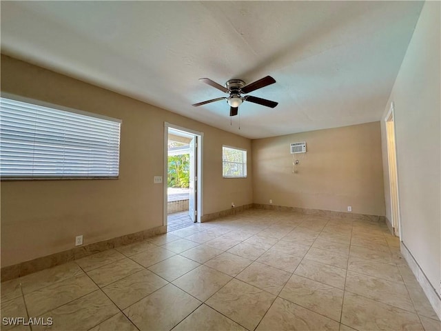 1434 Alhambra Dr, Fort Myers, FL 33901 - spare room with a ceiling fan, baseboards, a wall mounted AC, and light tile patterned floors