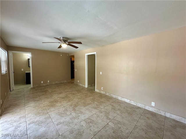 1434 Alhambra Dr, Fort Myers, FL 33901 - spare room featuring light tile patterned flooring, a ceiling fan, and baseboards