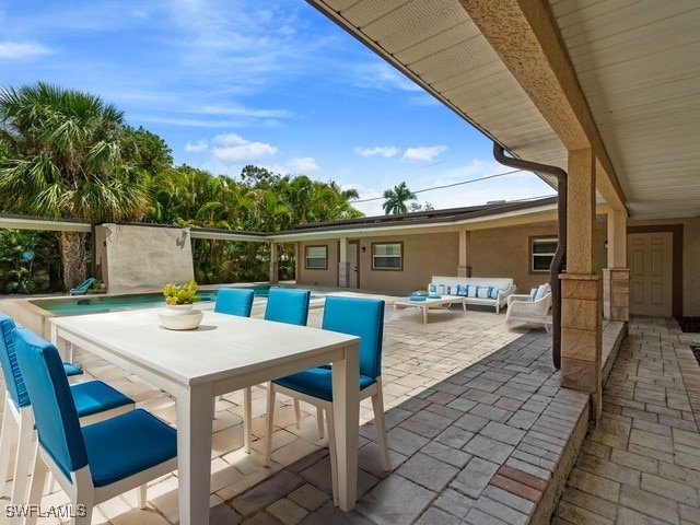 1434 Alhambra Dr, Fort Myers, FL 33901 - view of patio / terrace with a pool, outdoor lounge area, and outdoor dining area