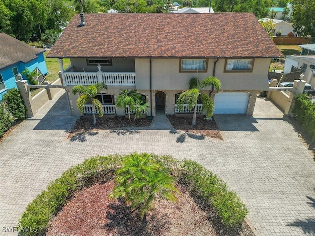 1434 Alhambra Dr, Fort Myers, FL 33901 - view of front facade with stucco siding, decorative driveway, a balcony, and a garage