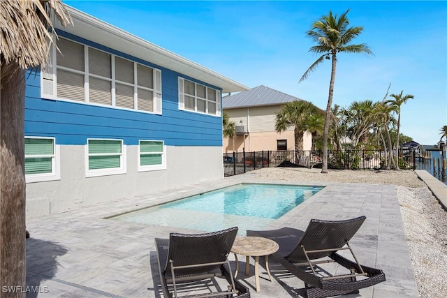 view of swimming pool featuring a fenced in pool, a fenced backyard, and a patio area