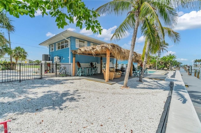 exterior space featuring fence, central AC, and a patio area