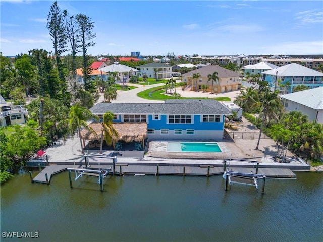 bird's eye view featuring a water view and a residential view