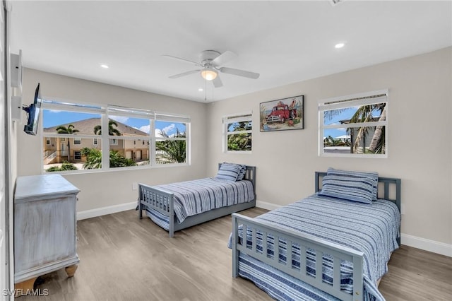 bedroom with baseboards, wood finished floors, recessed lighting, and a ceiling fan