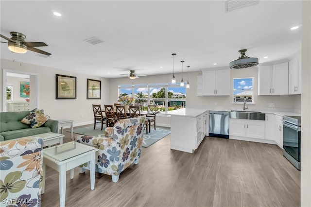 living room with ceiling fan, visible vents, recessed lighting, and light wood-type flooring