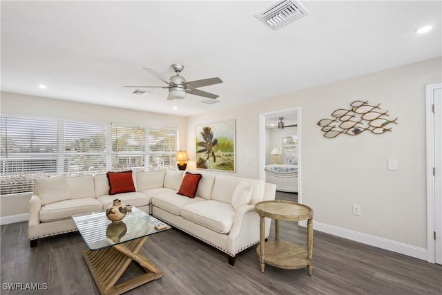 living area with a ceiling fan, wood finished floors, baseboards, and visible vents