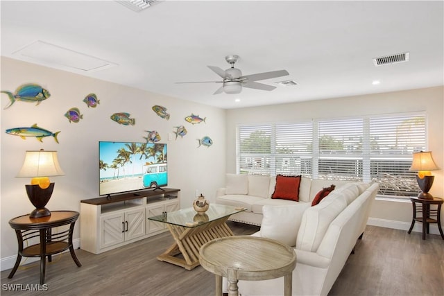 living area with ceiling fan, visible vents, and plenty of natural light