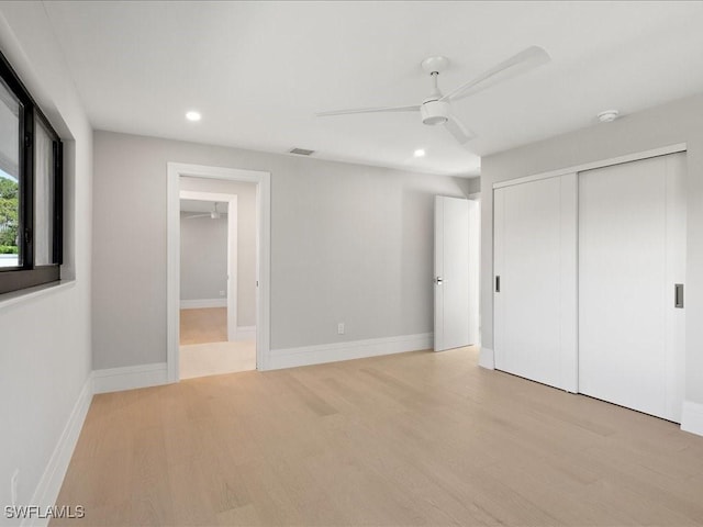 unfurnished bedroom featuring recessed lighting, a closet, ceiling fan, visible vents, and wood finished floors