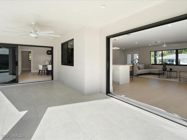 view of patio with an outdoor living space and a ceiling fan