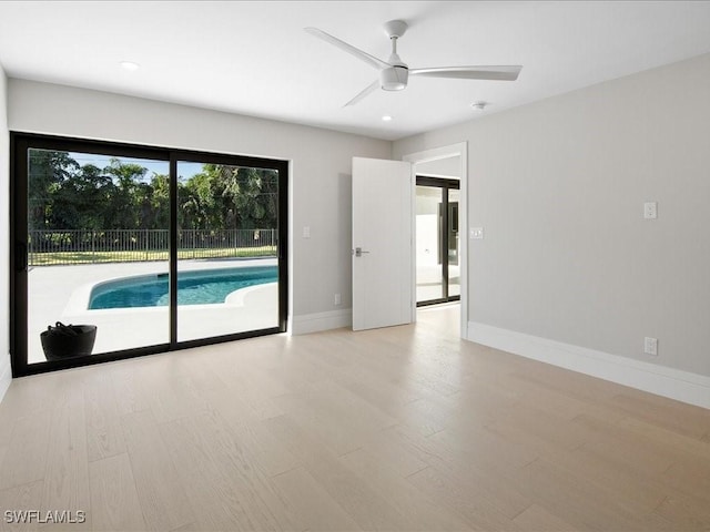 spare room with baseboards, recessed lighting, wood finished floors, and a ceiling fan