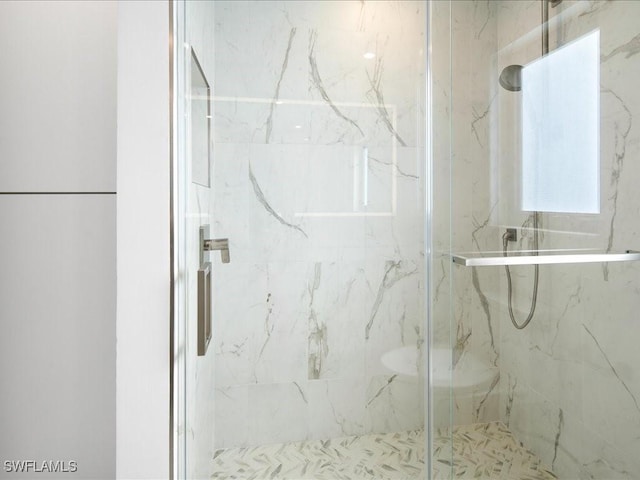 full bathroom with a marble finish shower