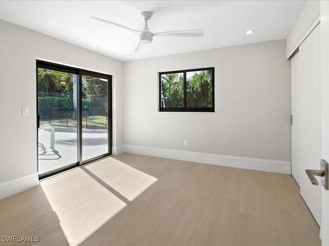 unfurnished room with recessed lighting, a ceiling fan, light wood-style flooring, and baseboards