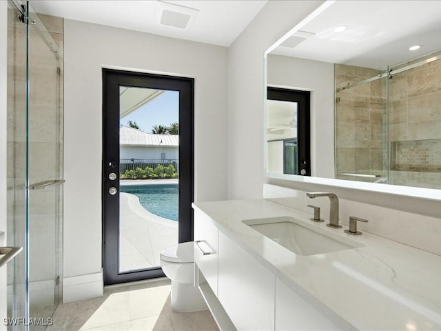 bathroom featuring recessed lighting, tile patterned flooring, a shower stall, toilet, and vanity