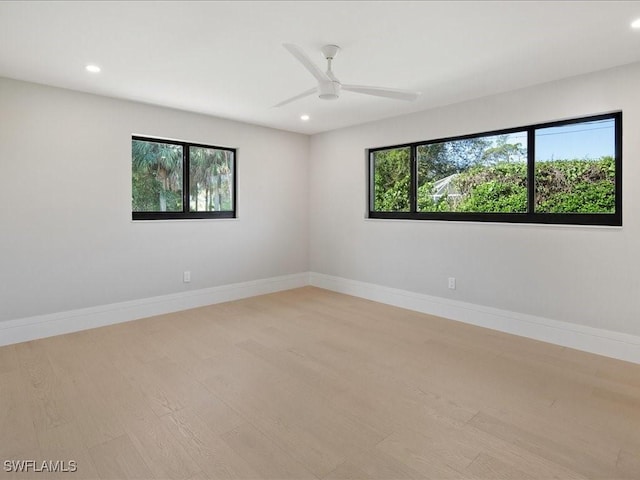 empty room featuring baseboards, recessed lighting, ceiling fan, and light wood-style floors