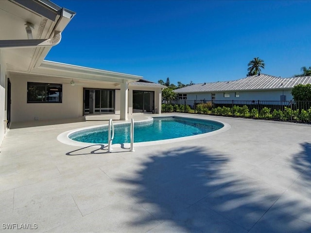 view of pool with fence, a ceiling fan, a fenced in pool, and a patio area